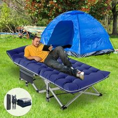 a man laying on top of a blue chaise lounge chair next to a tent