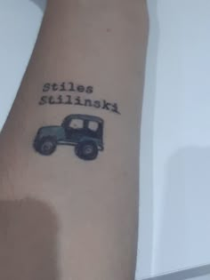 a person with a tattoo on their arm that says stilts stinkin'in black ink