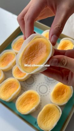 someone is placing an egg in the middle of some deviled eggs on a tray