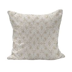 a white pillow with an intricate pattern on it's back and the front is made out of fabric