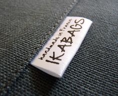 a label on the back of a jacket that says, bages made in japan