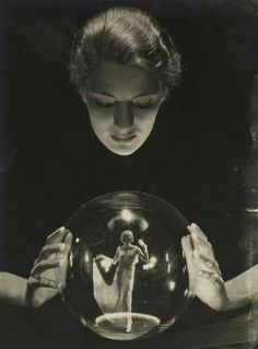 a woman holding a crystal ball in her hands