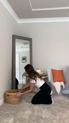 a woman sitting on the floor in front of a mirror