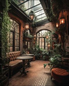 an indoor room with lots of plants on the walls and tables in front of it