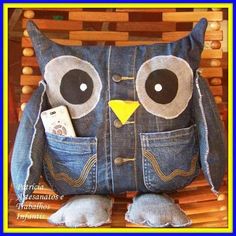 an owl made out of jeans sitting on top of a wooden chair with a cell phone in it's pocket