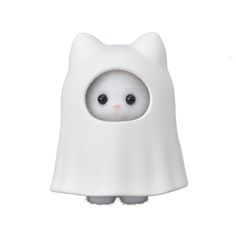 a white cat figurine with black eyes and a cape on it's head