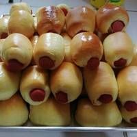 a pile of hot dogs wrapped in buns