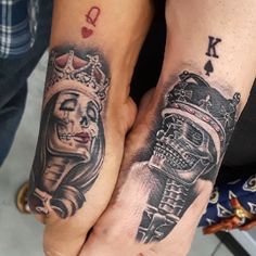 two people holding hands with tattoos on them