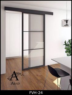 an open glass door in the middle of a room with wood flooring and white walls