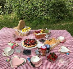 a picnic table with food and fruit on it