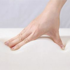 a person's hand on top of a mattress