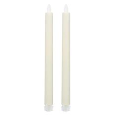 two white candles sitting next to each other