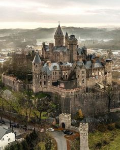 an aerial view of a castle in the middle of town