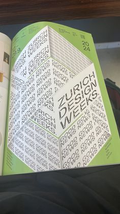 an open book with the words design week written in black and white on it's cover