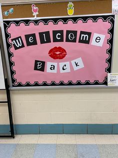 a welcome back door sign in front of a bulletin board