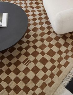 a coffee table sitting on top of a brown and white rug