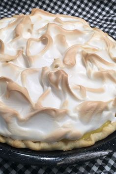 a pie sitting on top of a checkered table cloth