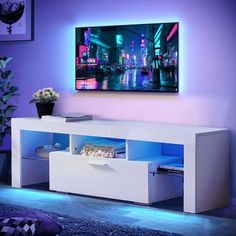 a white entertainment center in a living room with purple walls and blue lights on the wall