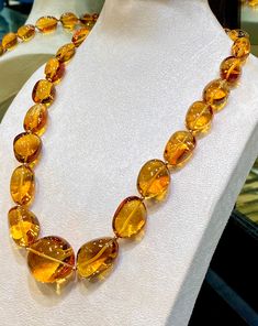 Natural Citrine fine Quality fancy Tumble Shape Necklace with 23 pieces high-End quality Gems by GemShopOnline. These rich color beauty gemstone is hand cut in different sizes & carefully lined up. They are cut in smooth fancy tumble  shape. A special cut that makes these amazing quality gemstones unique. The large necklace is almost eye clean (hardly it will show minor inclusions in some pieces) and is beautifully crystal like clear. It is string with lobster clip & ready to wear.  For safety! Luxury Unique Citrine Necklaces, Luxury Faceted Citrine Necklaces, Luxury Amber Necklace With Gemstone Beads, Luxury Multi-stone Orange Jewelry, Luxury Amber Gemstone Necklace, Elegant Luxury Amber Crystal Necklaces, Amber Gemstone, Artisan Bracelets, Large Necklace