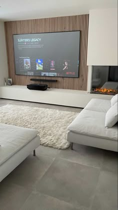 a large flat screen tv mounted to the side of a wall in a living room