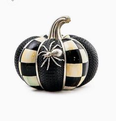 a black and white pumpkin with a spider on it