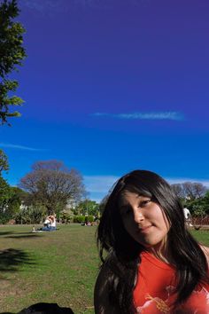 a woman in a red shirt is holding a frisbee