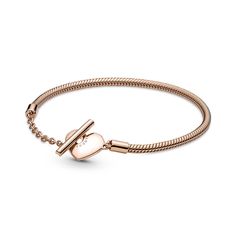 a rose gold bracelet with a heart charm on the clasp and a chain around it