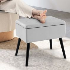 a person laying on top of a foot stool