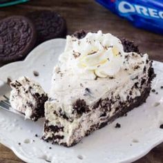 a piece of ice cream pie on a plate with a fork and oreo cookies