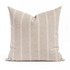 a beige and white striped pillow on a white background, with the back side turned down