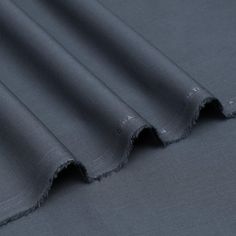 the fabric is dark grey and has frayed edges