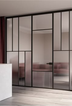 an empty room with sliding glass doors and red curtains