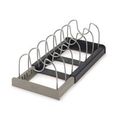 a metal rack with several pairs of scissors in it on a white background, there is no image here to provide a caption for