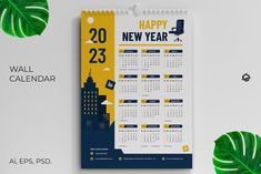 a wall calendar with a green leaf next to it on a white background and the words happy new year