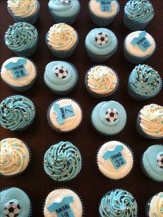 cupcakes with blue frosting and soccer decorations