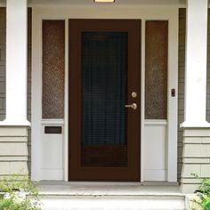 the front door of a house with brown and white trim on it's sides