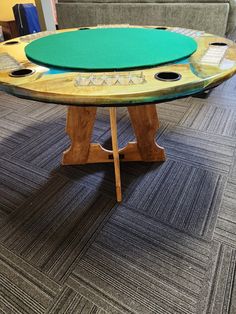 a surfboard shaped coffee table sitting on top of a carpeted floor