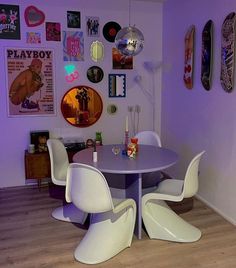 a dining room with purple walls and pictures on the wall