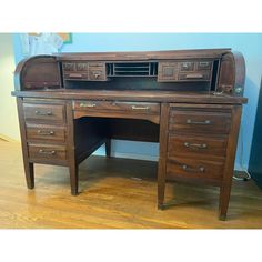 an old fashioned wooden desk with drawers