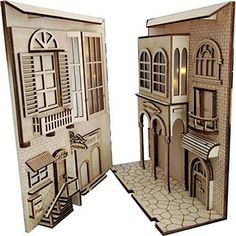 a paper cut out of a building with windows and shutters on the front door