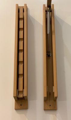 two pieces of wood with metal handles on each side and one piece missing from the back