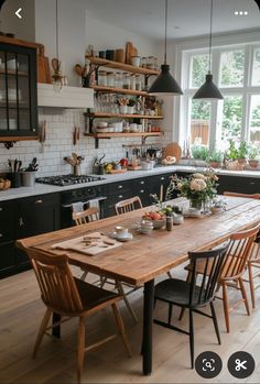 a wooden table sitting in the middle of a kitchen