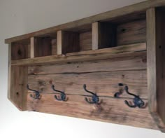 a wooden shelf with hooks on it