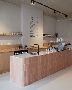 the counter in this restaurant is made of bricks and has many dishes on top of it