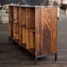 a wooden shelf sitting on top of a hard wood floor