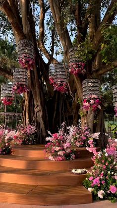 an outdoor wedding setup with flowers on the table and chairs around it, overlooking the water