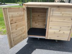 a wooden storage shed with its doors open