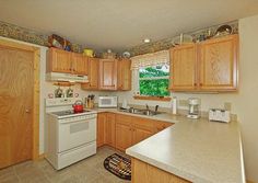 a kitchen with wooden cabinets and white appliances