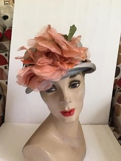 "Vintage 1950's 1960's light Gray Straw hat with Dark Peach flowers. The label is *Grayce Hats*. Does have condition issues and will be sold as is. (SEE PIX). *MORE INFORMATION BELOW* CONDITION: Has discoloration around the inside brim in the front on the straw and on the band/ribbon (SEE PIX). On the inside band on the right side there is a small dark spot. In the back of the hat on the brim area there is some wear. This appears to be from where the hatpin was always used (SEE PIX). Sold As Is! Vintage Spring Cloche Hat With Curved Brim, Vintage Cloche Hat With Curved Brim For Spring, Retro Spring Cloche Hat, Vintage Cloche Hat For Spring, Vintage Gray Brimmed Hat, Vintage Spring Cloche Hat For Party, Vintage Short Brim Fascinator For Garden Party, Vintage Mini Hats For Kentucky Derby Garden Party, Vintage Fitted Hat For Spring