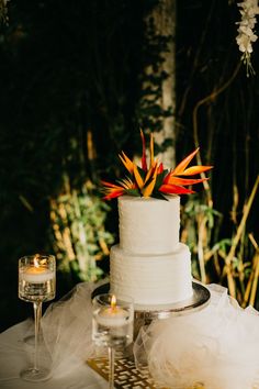 a white wedding cake sitting on top of a table